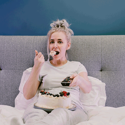 Women eating cake on bed