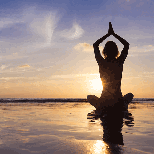 Women performing Yoga on beach