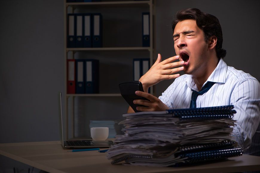 Man Yawning in office