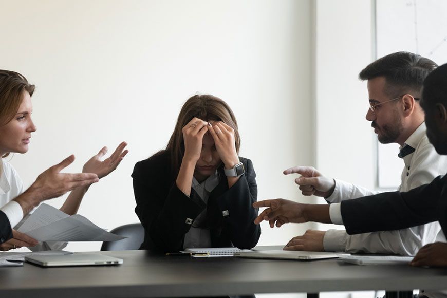 An irritated women surrounded by colleagues  