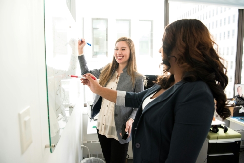 Two women in workplace enjoying work